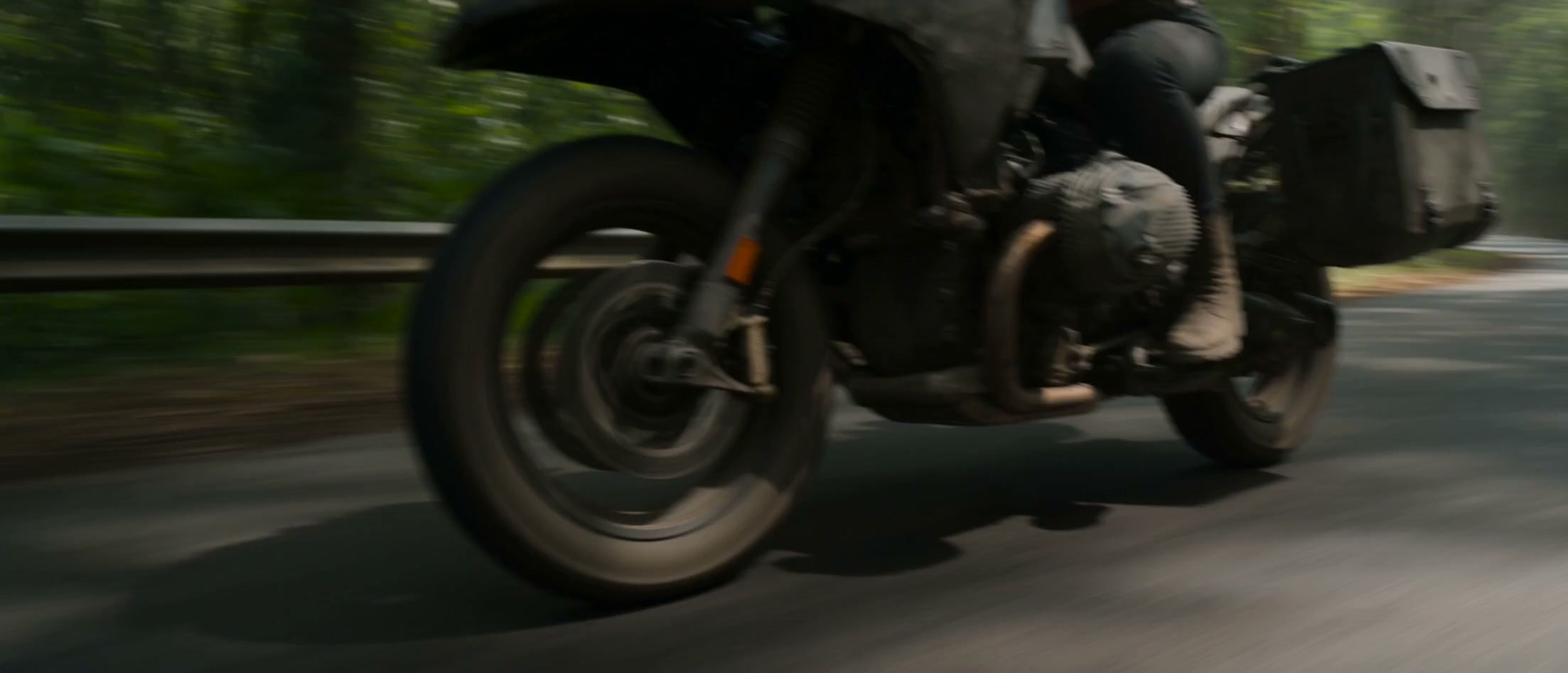 A hyper-real cinematic sequence set on a narrow forest highway cutting through dense tropical rainfo...